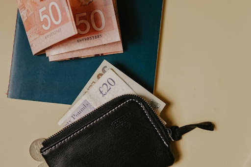 10 and 10 euro banknotes partially visible in a black leather wallet
