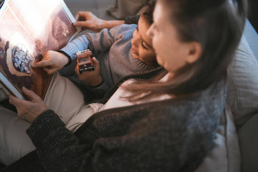 Woman sitting with her son, smiling and relaxed