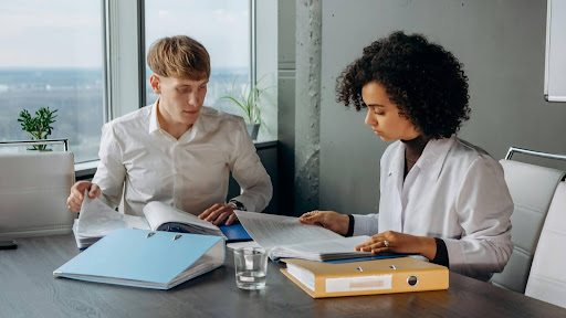 Man and woman reviewing documents together at a table