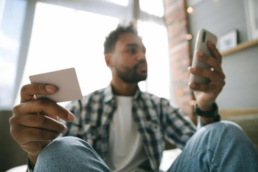 Man using a smartphone to send money