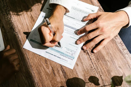 Person filling out a payday loan application form.