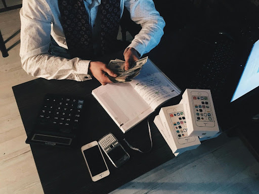 Accountant counting dollar bills at a desk
