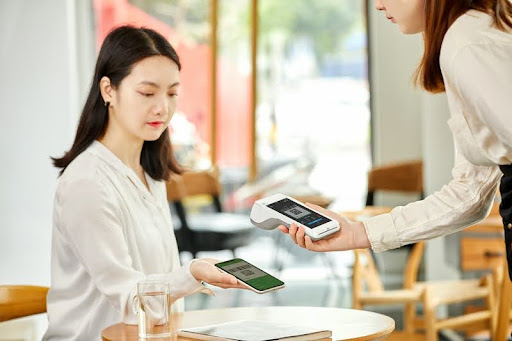 Woman holding a credit card and looking concerned