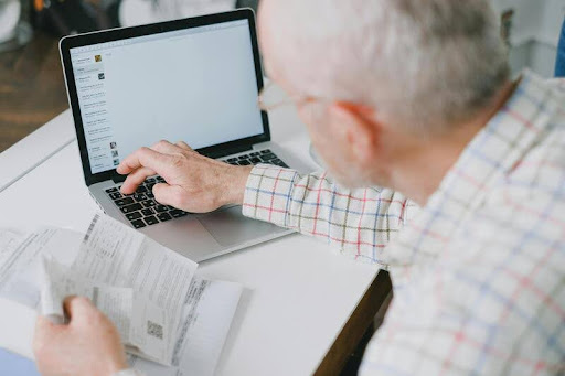 Man using a laptop to manage business finances