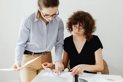 Two women talking in a modern office setting