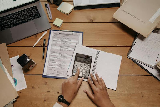 Person using a calculator at a desk