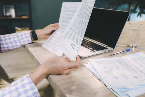 Person reviewing documents at a desk