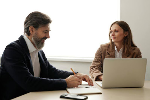 Man and woman having a conversation at a desk