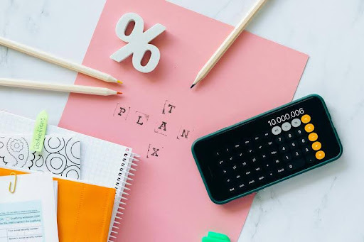 Calculator and notebook on a wooden table