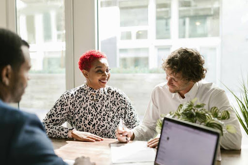 Group of business professionals discussing data around a table