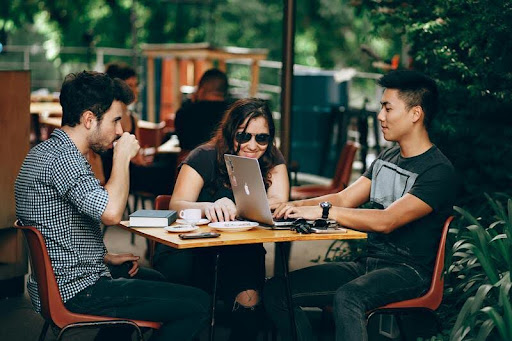 Three people having a business meeting around a table