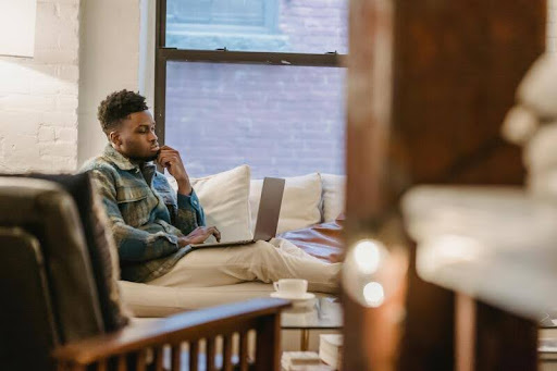 Man using a laptop in his living room.