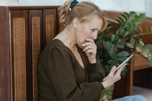 Woman looking surprised at her smartphone after reading online information.