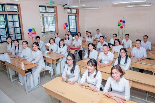 High school students sitting at desks in a classroom, listening to a lesson.