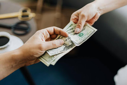 Person receiving cash from another hand