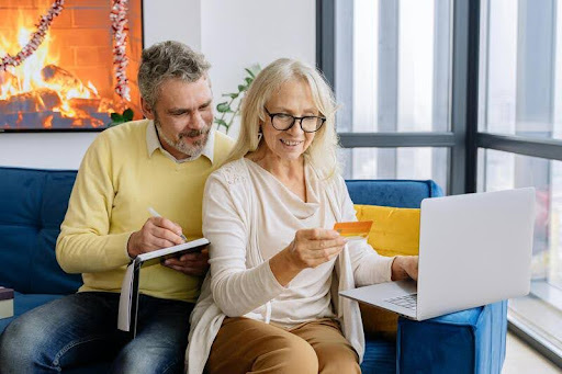 Couple using a laptop while reviewing a loan document