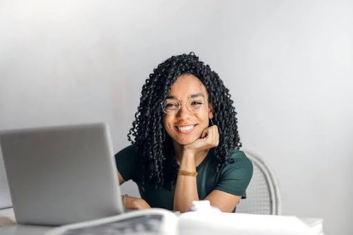 Student sitting at desk using a laptop to research student loan options.