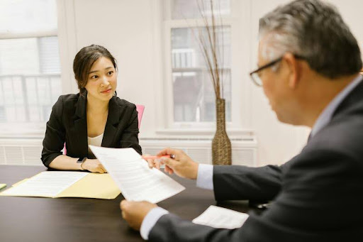 Man and woman reviewing financial documents at a table.