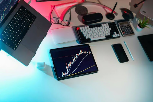 Digital asset charts on a sleek tablet and laptop, representing future financial convergence and deep-data analysis.