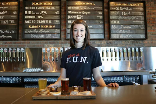 Woman standing at a sleek counter, engaging with a service or transaction in a modern, minimalist space.